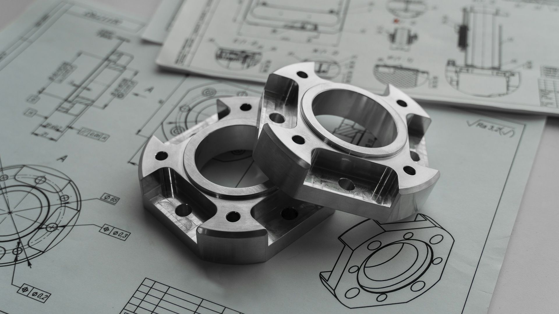 Machined metal parts on engineering drawings